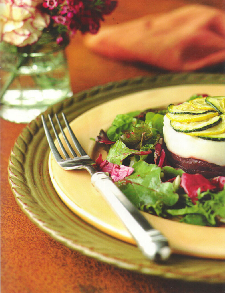 roasted beet, goat cheese soufflé terrine topped with zucchini and summer squash