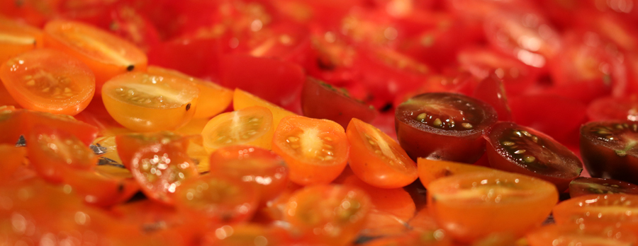 halved yellow, brown betty and red cherry tomatoes