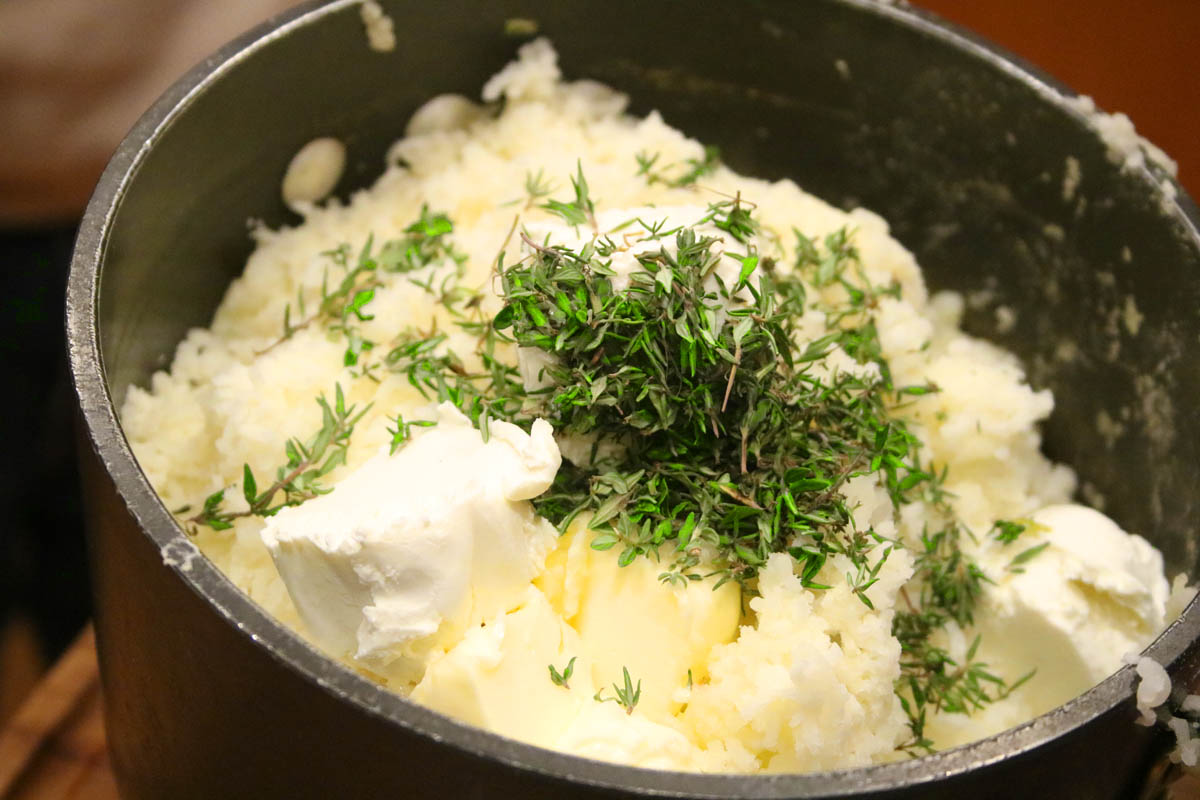 Pot of Mashed potatoes with butter,goat cheese and fresh thyme