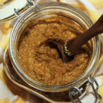 Turmeric Yellow Curry in a glass jar with a wooden spoon