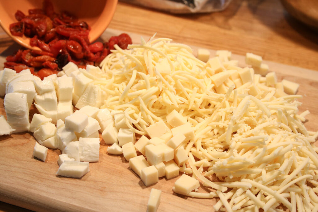 Chopped and Grated! Chunks of mozzarella and grated gruyere with oven dried tomatoes