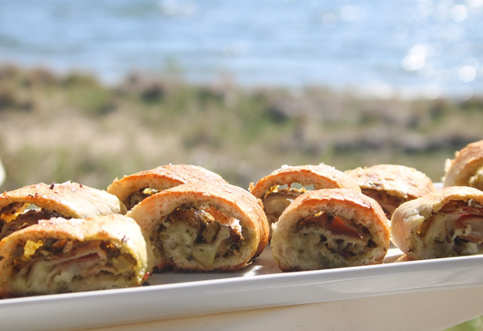 On deck - prosciutto pesto puffs are ready with Lake MIchigan behind