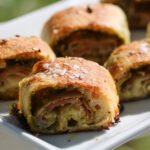 Pop these puppies right in! Sliced prosciutto pesto puffs on a white rectangular tray