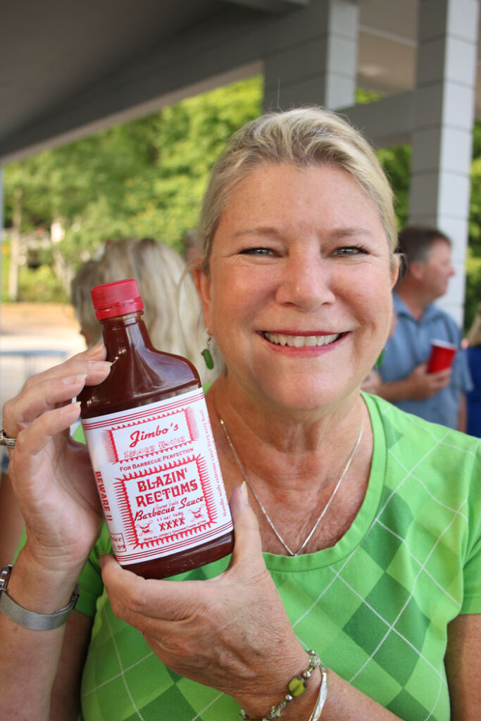 Woman holding a jar of Jimbo\'s hot sauce