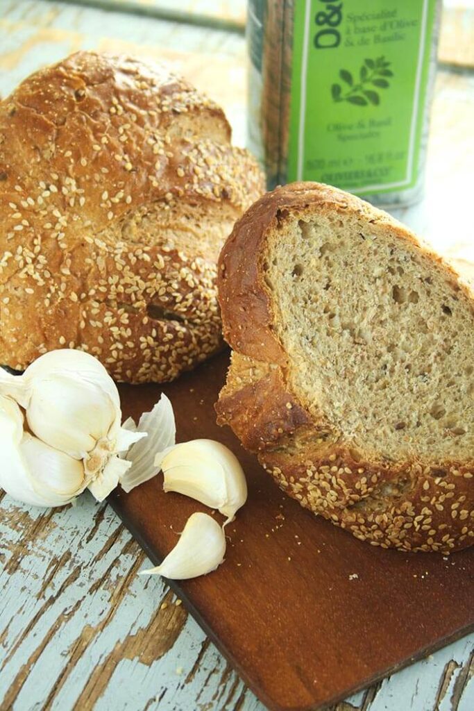 Sourdough bread with garlic head and tin of olive oil