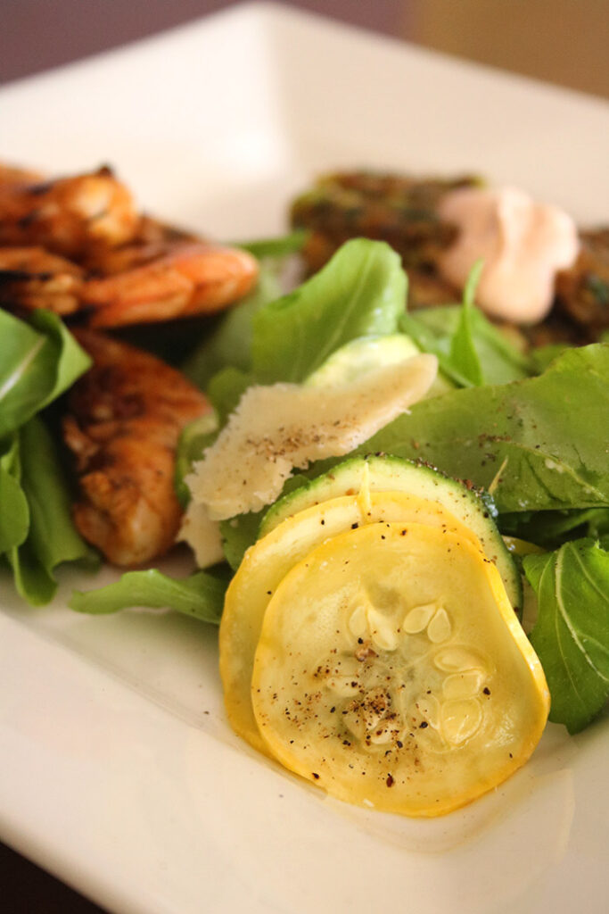 Summer Salad with Grilled Shrimp on a square white plate