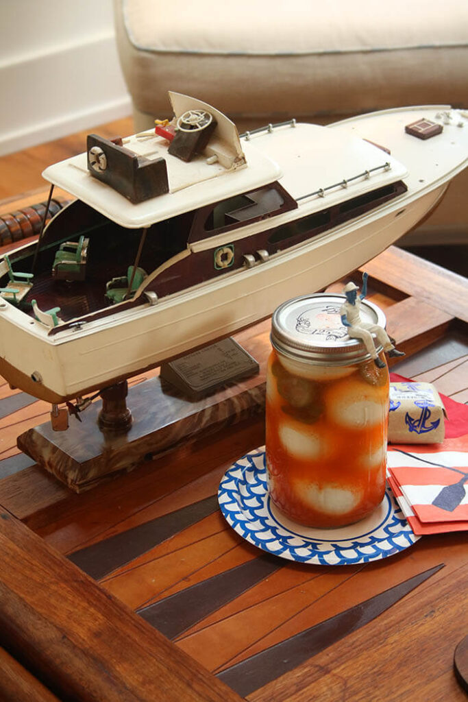 Pickled Eggs in a mason jar and Captain Blue sitting atop. Plus a model boat