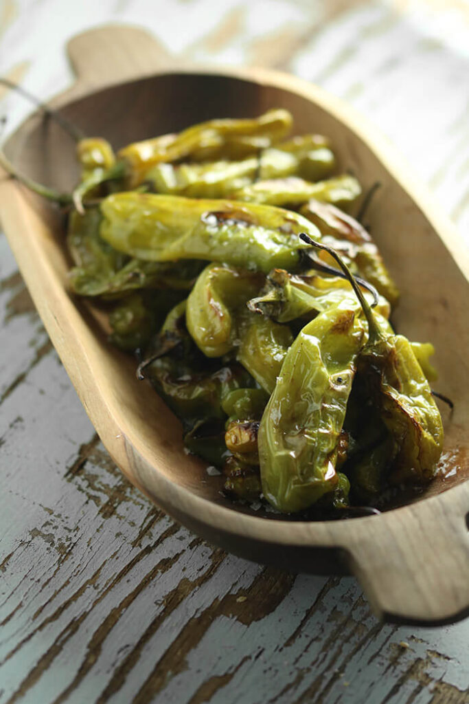 Roasted Shishito Peppers in a wooden bowl