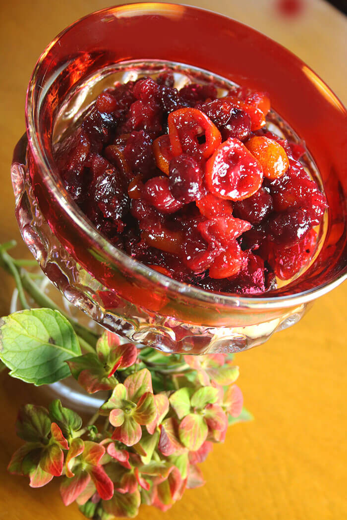 Spiced Cranberry Chutney in a cranberry glass pedestal dish with fall hydrangea