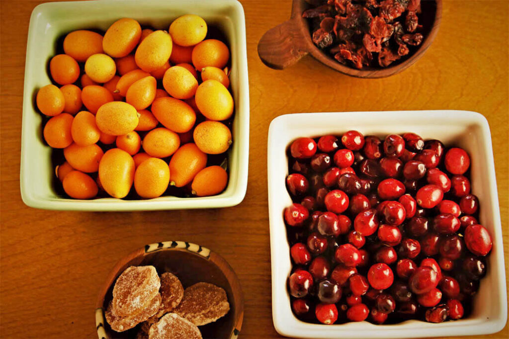 Kumquats, Crans & Ginger in square market baskets and wooden bowls