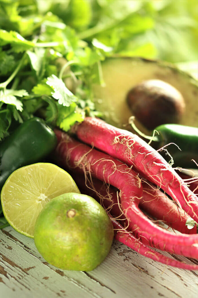 Prepping the Toppings for posole - limes, radishes, jalapenos, cilantro and avocado