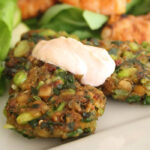 close up of chickpea and edamame fritters with chili dipping sauce
