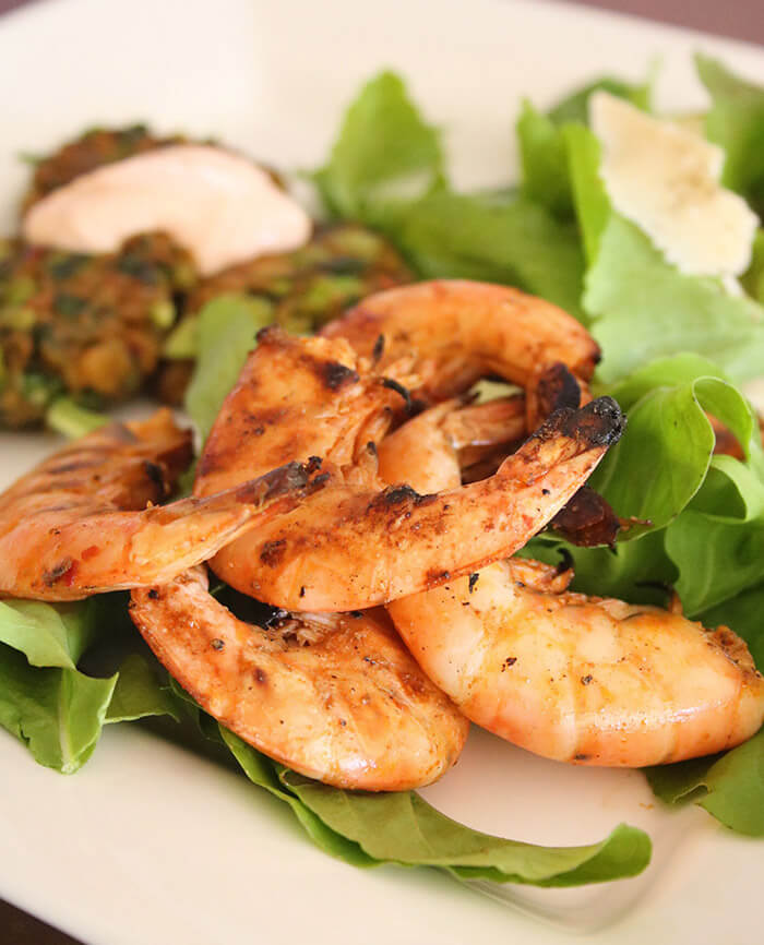 Salt and Pepper Grilled Shrimp on arugula with edamame fritter and chipotle aioli