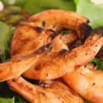 Spicy Grilled Shrimp close up with arugula bed