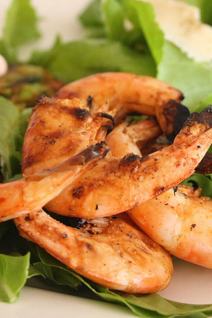 Spicy Grilled Shrimp close up with arugula bed