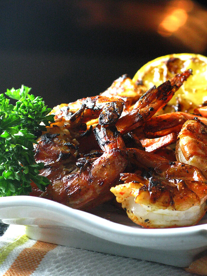 Sriracha and Chipotle Tabasco Marinated Grilled Shrimp with grilled lemon and parsley