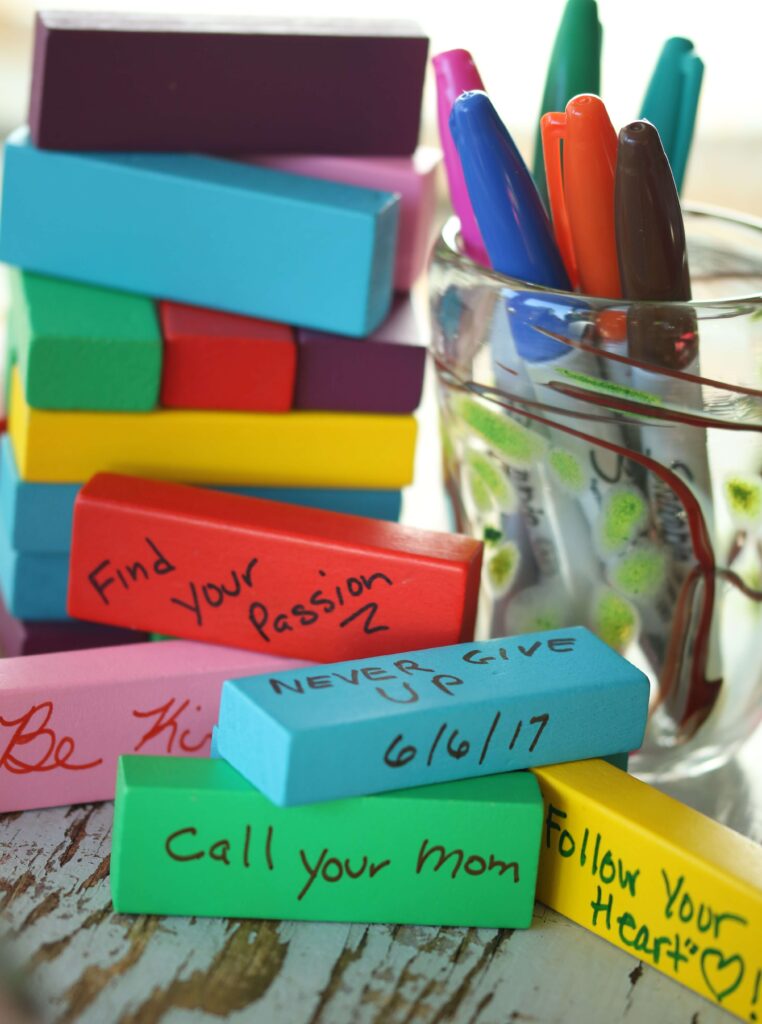 Jenga Memories - close of Jenga wishes with a glass full of sharpies