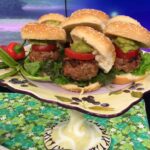 Juicy Turkey Burger sliders on mini buns with guacamole and tomato slice on a pedestal plate