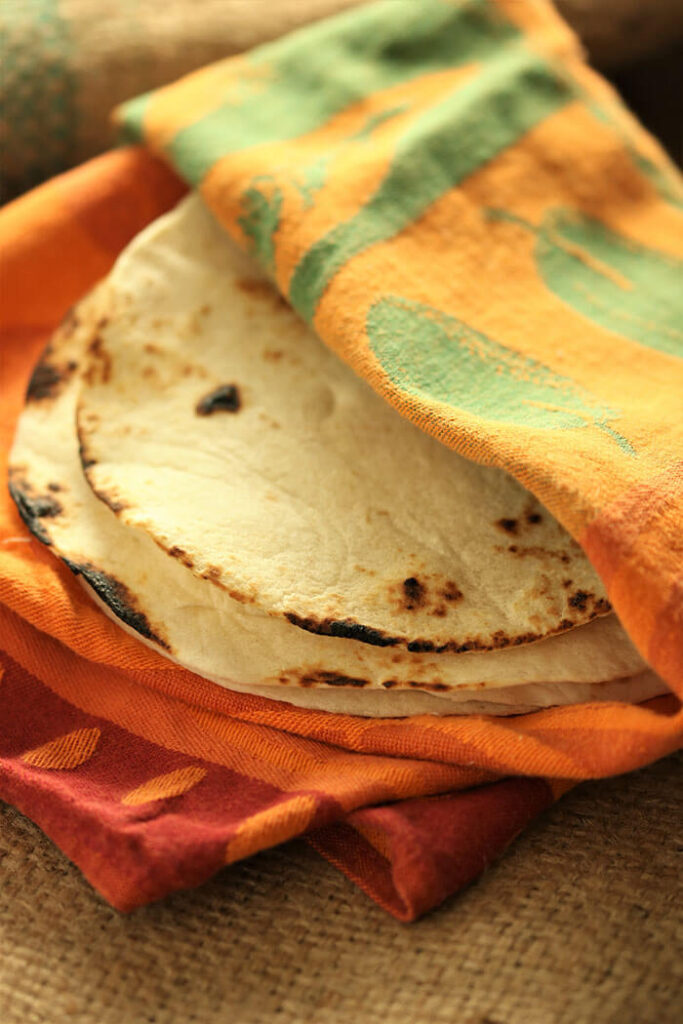 Grilled tortillas wrapped in a tea towel