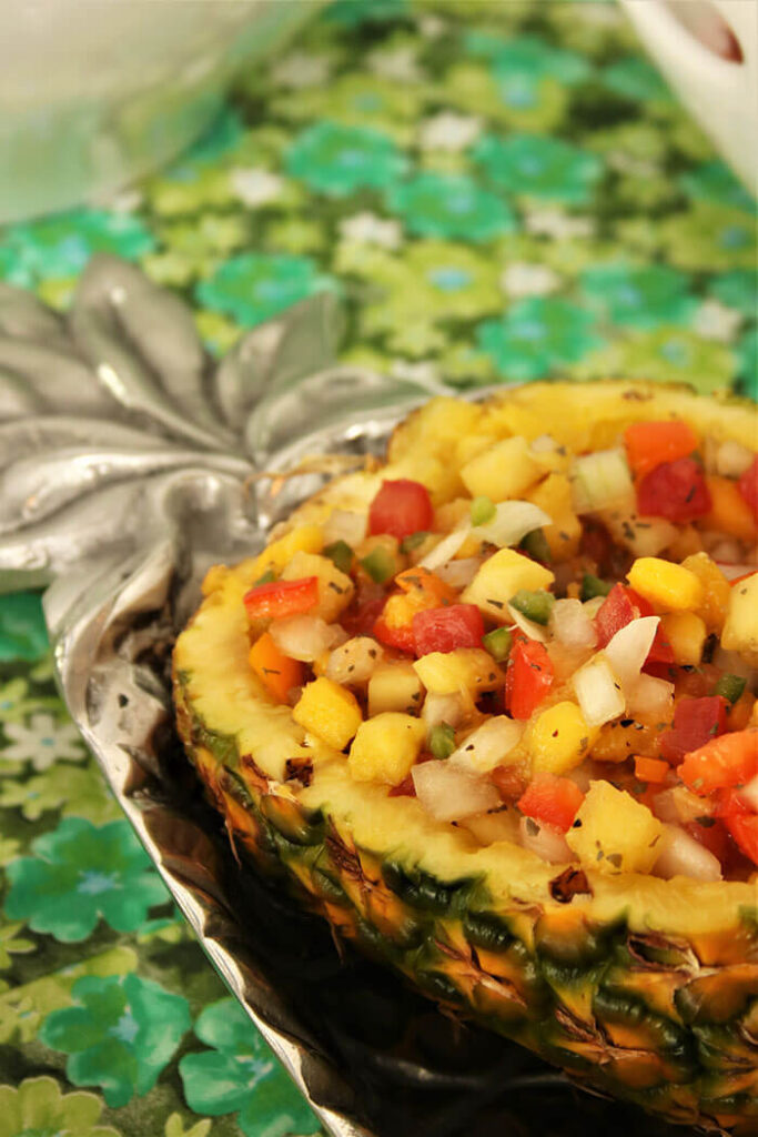 Pineapple Salsa in a pineapple half, on a pewter tray shaped like a pineapple