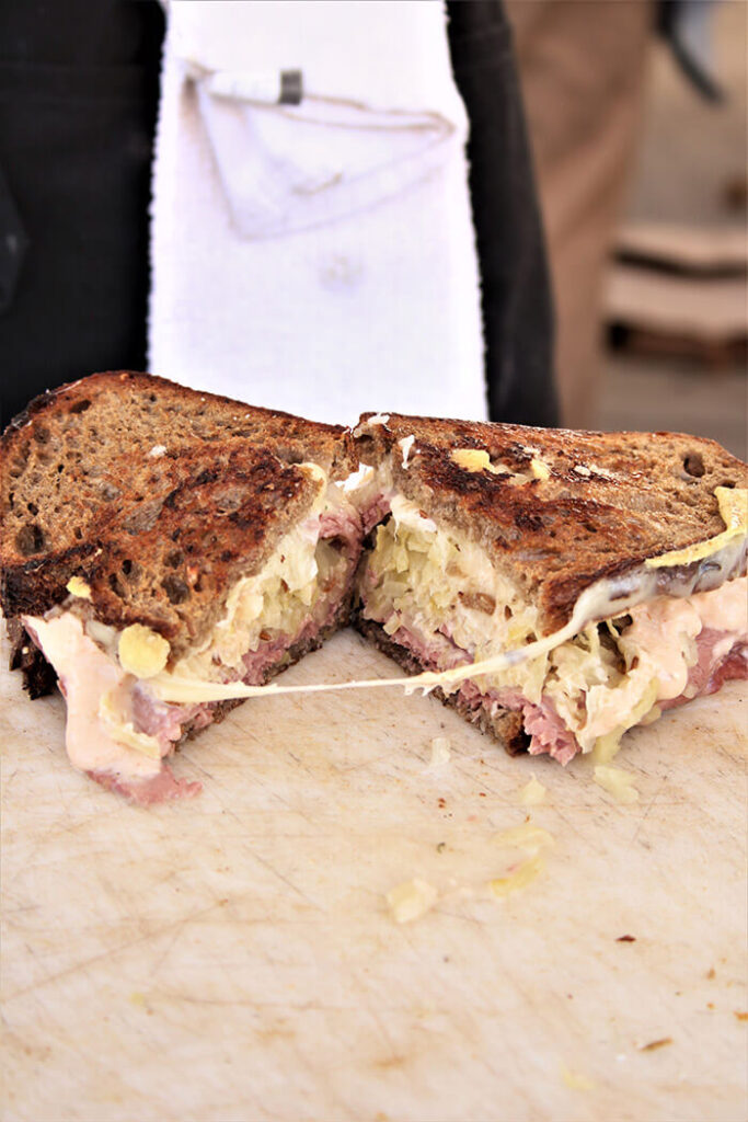 Reuben sandwich hot off the grill at farmers market