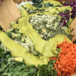 Curried Avo Dressing with Super Greens: arugula, cabbage, shredded carrots with hemp hearts and pumpkin seeds