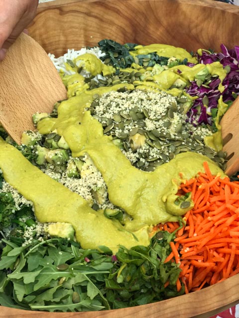 Curried Avo Dressing on Superfood Salad in a wooden bowl with servers