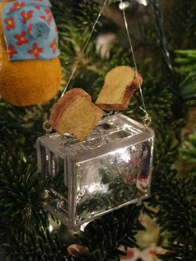 tree ornament of a toaster with two pieces of toast popping out