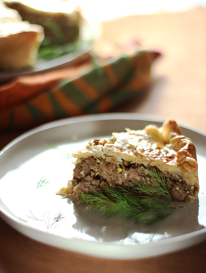 russian meat pie slice on a white plate