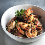 Shrimp and White Beans with Roasted Garlic & Mint in a white bowl