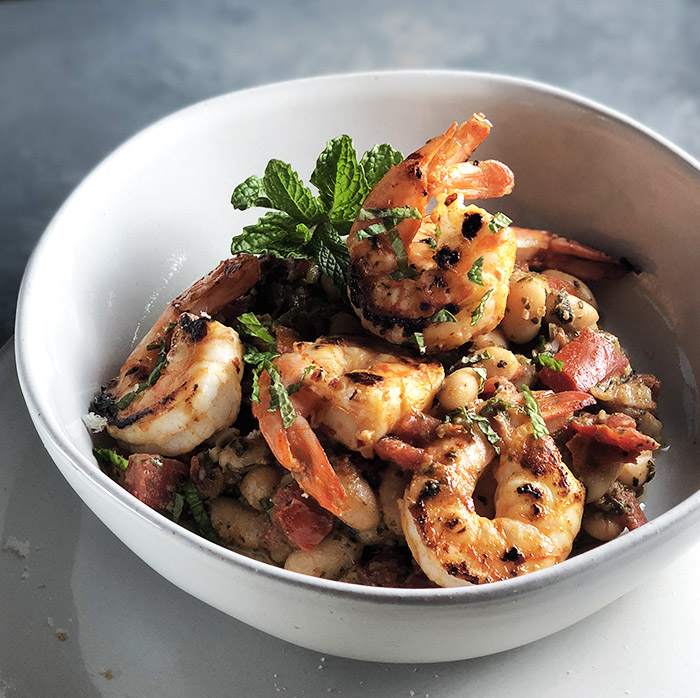 Shrimp and White Beans with Roasted Garlic & Mint in a white bowl