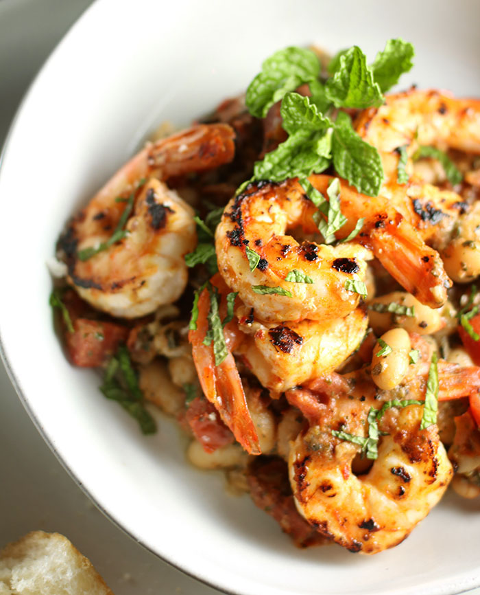 Close up of a shrimp and white beans with roasted Garlic and Mint Pesto