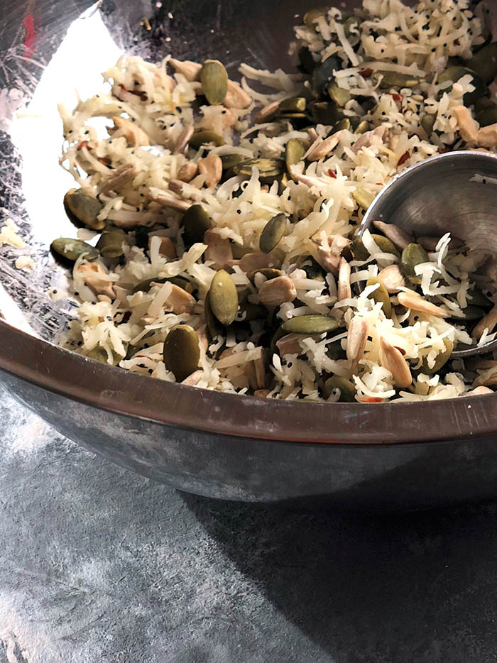 All the seeds and cheeses in a bowl with measuring spoon