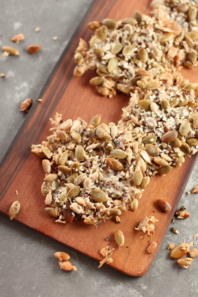 Cheese Crisp Chock Full of Seeds on a wooden board