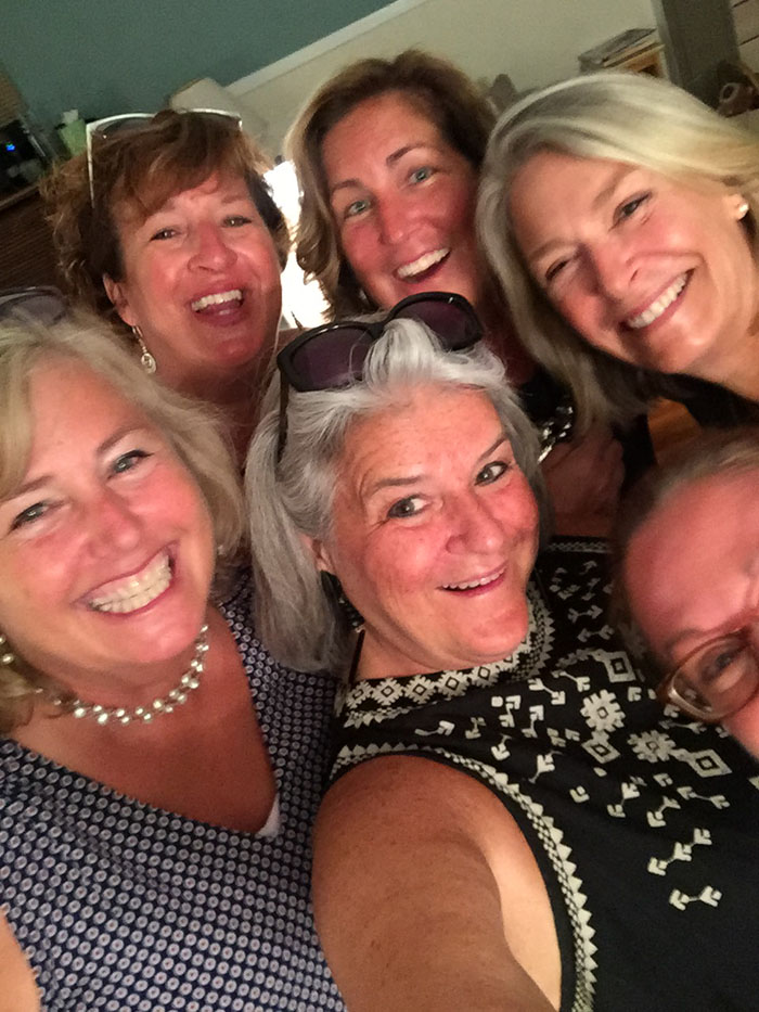 Six smiling ladies after eating so much salad