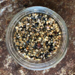 Zesty Spice Rub in a glass jar on a rusty pan