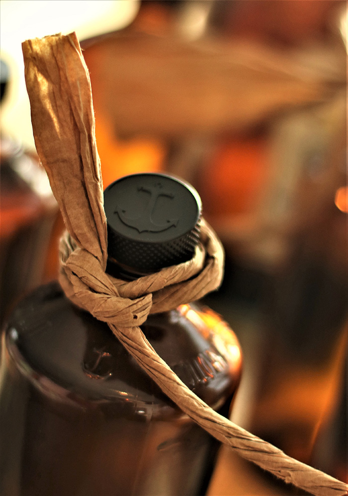 Bottle Top with anchor, on brown bottle, tied with raffia