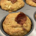 Close up of a Corn muffin with cheddar, apple and bacon flags